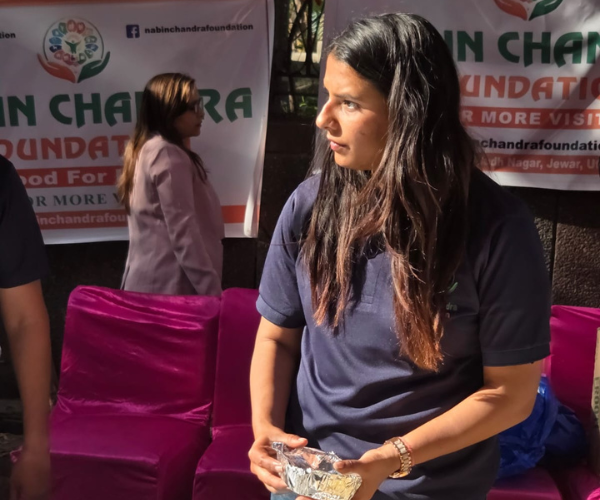 Female volunteer holding a food container ready to distribute